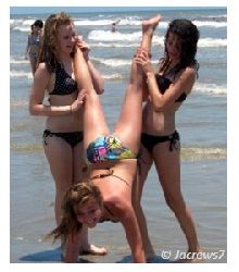 Bikini Girls holding another girl from legs helping her to do a handstand