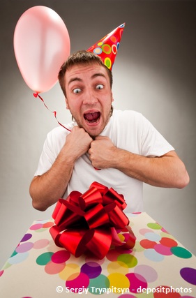 Surprised man with a birthday gift