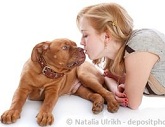 girl kissing a dog