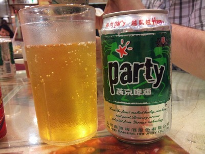 A glass full of beer with a beer can