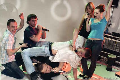 Crazy party group doing karaoke twister moves