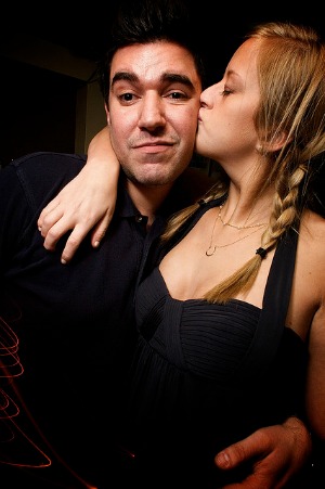 Guy with a weird face while being kissed