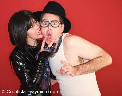 Girl biting on the cheeks of a guy