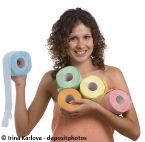 Girl in towels holding many tissue paper rolls