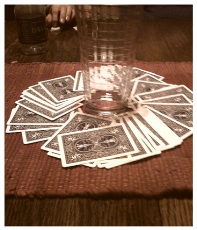 a deck of playing cards with a glass in the center