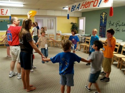 Kids playing game while holding hands in circle Kids playing game while holding hands in circle