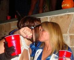 Girls kissing while drinking