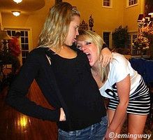 Girl biting on the chest of another girl