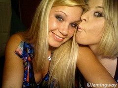 two blondes smiling and posing for a kiss