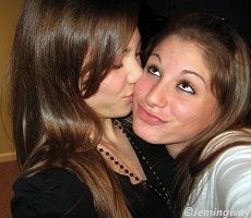 Brown haired girl kissing on the cheecks