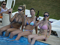 girls in bikini showing cleavage at swimming pool