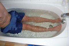Cold bathing with ice-cubes in bathtub
