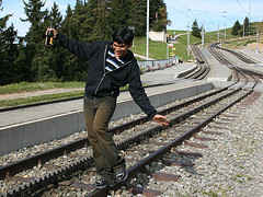 Balancing himself on a railway track