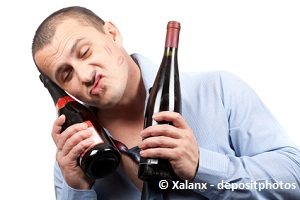 drunken man with wine bottles making funny face