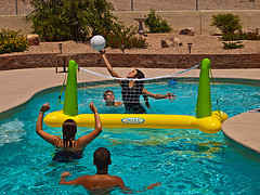 Playing swimming pool volley ball