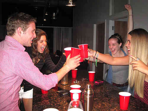 Three hot girls and a guy drinking at party