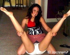 black haired girl stretching the legs of other girl